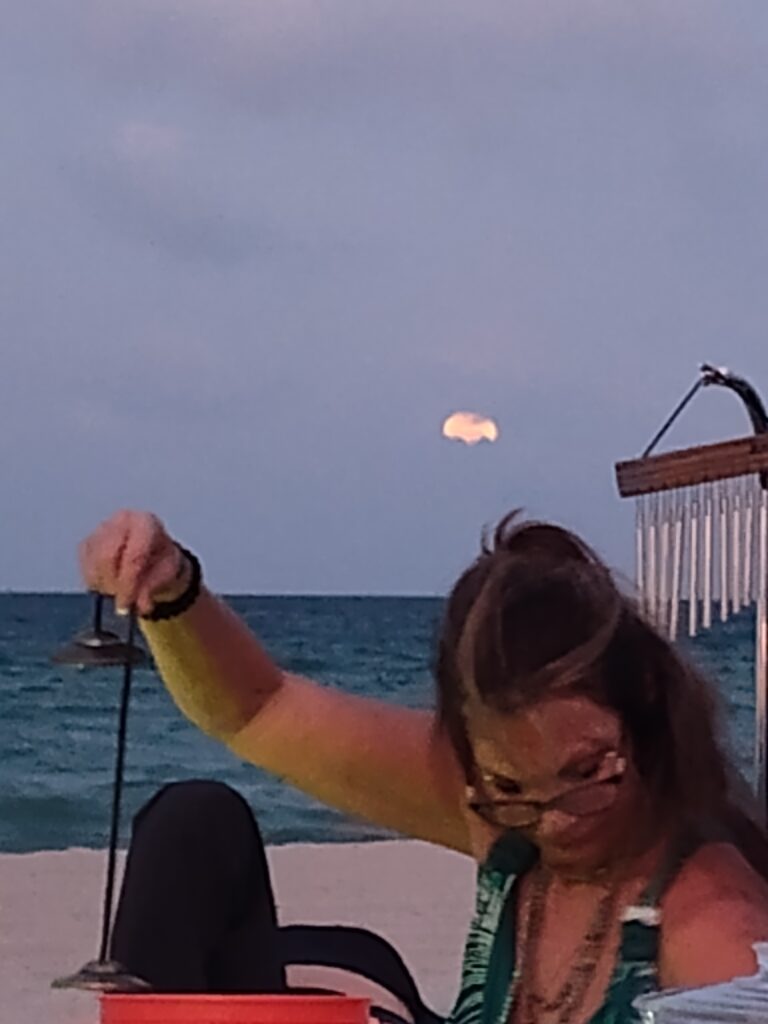 Strawberry full moon behind Kelly