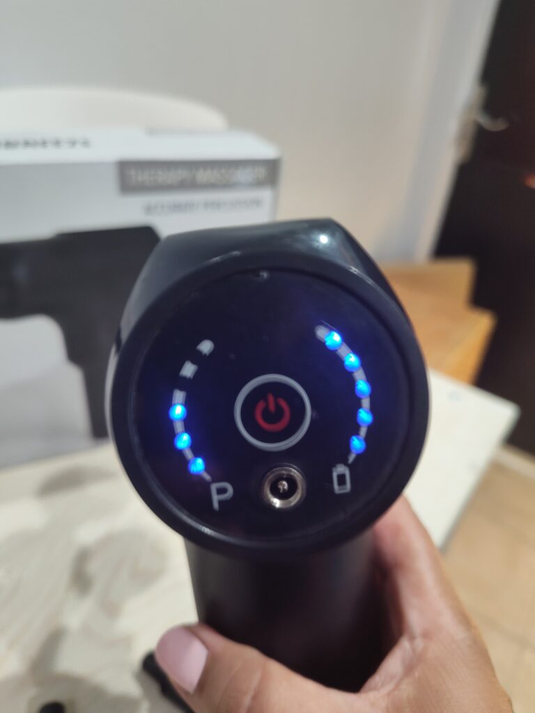 Massage gun with blue indicator lights for speeds and battery life