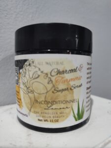 A jar of Inconditionnel L'Amour's all natural charcoal and turmeric sugar scrub.