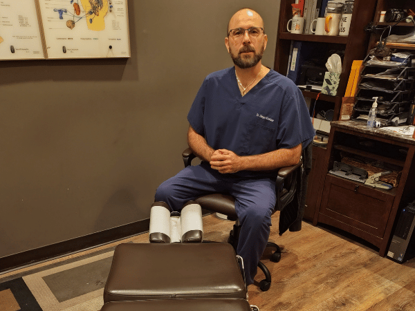 Dr. Diego Kostzer and his drop table at Fit 4 Action Chiropractic