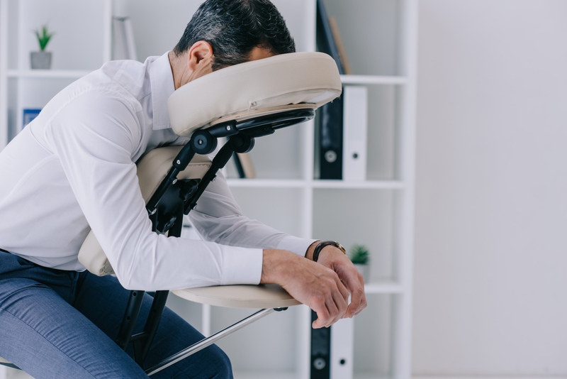 Man in white shirt in a massage chair