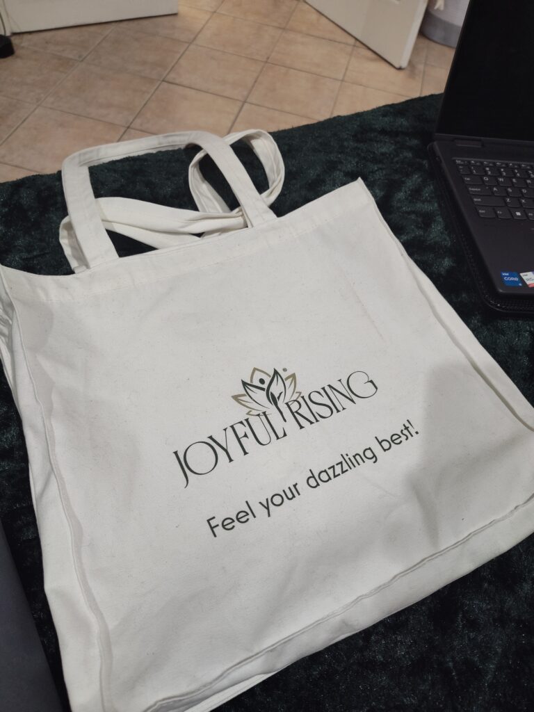 White cotton tote bag with Joyful Rising logo and tagline Feel Your Dazzling Best