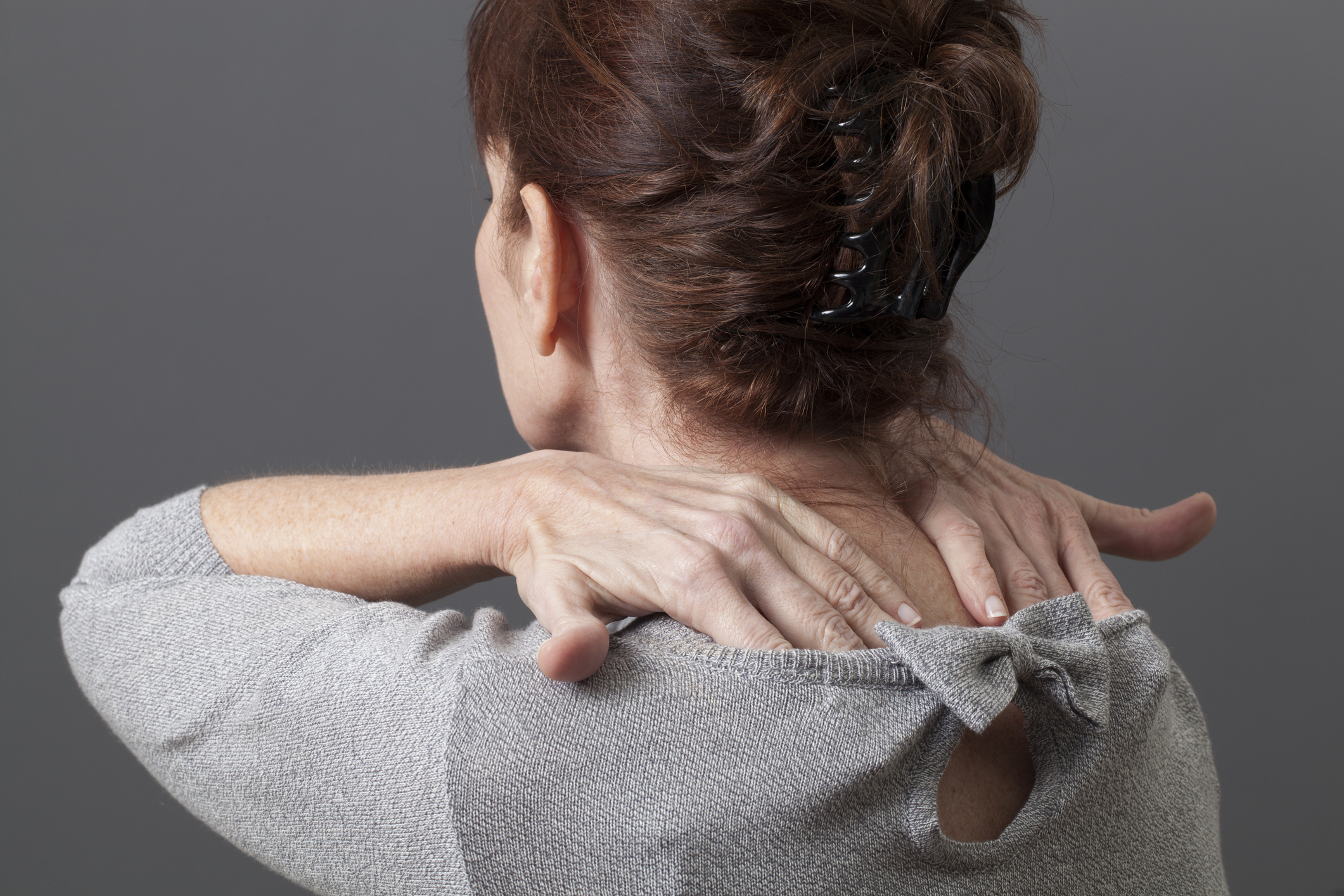 Woman massaging her shoulders