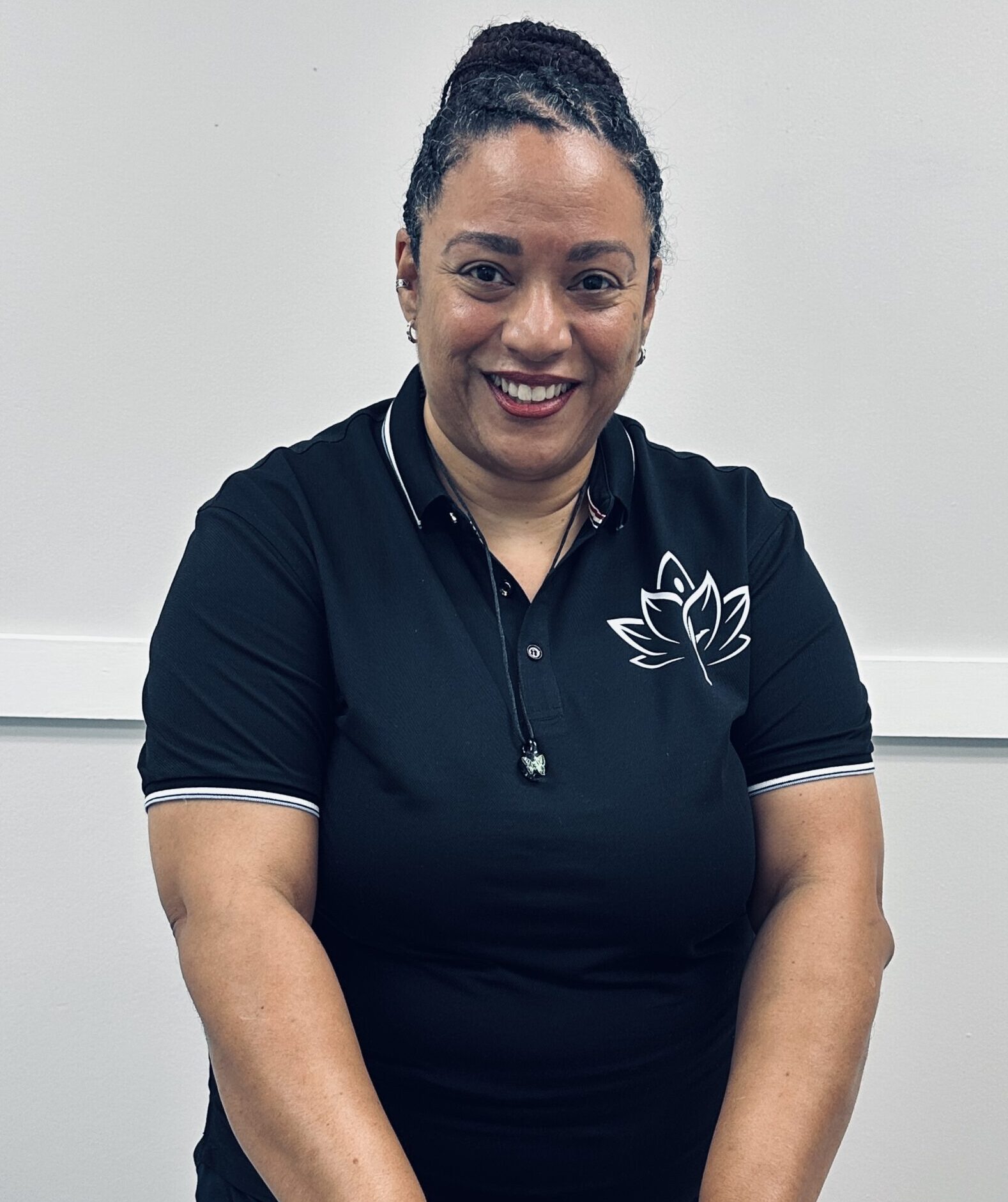 Black woman in polo shirt with logo